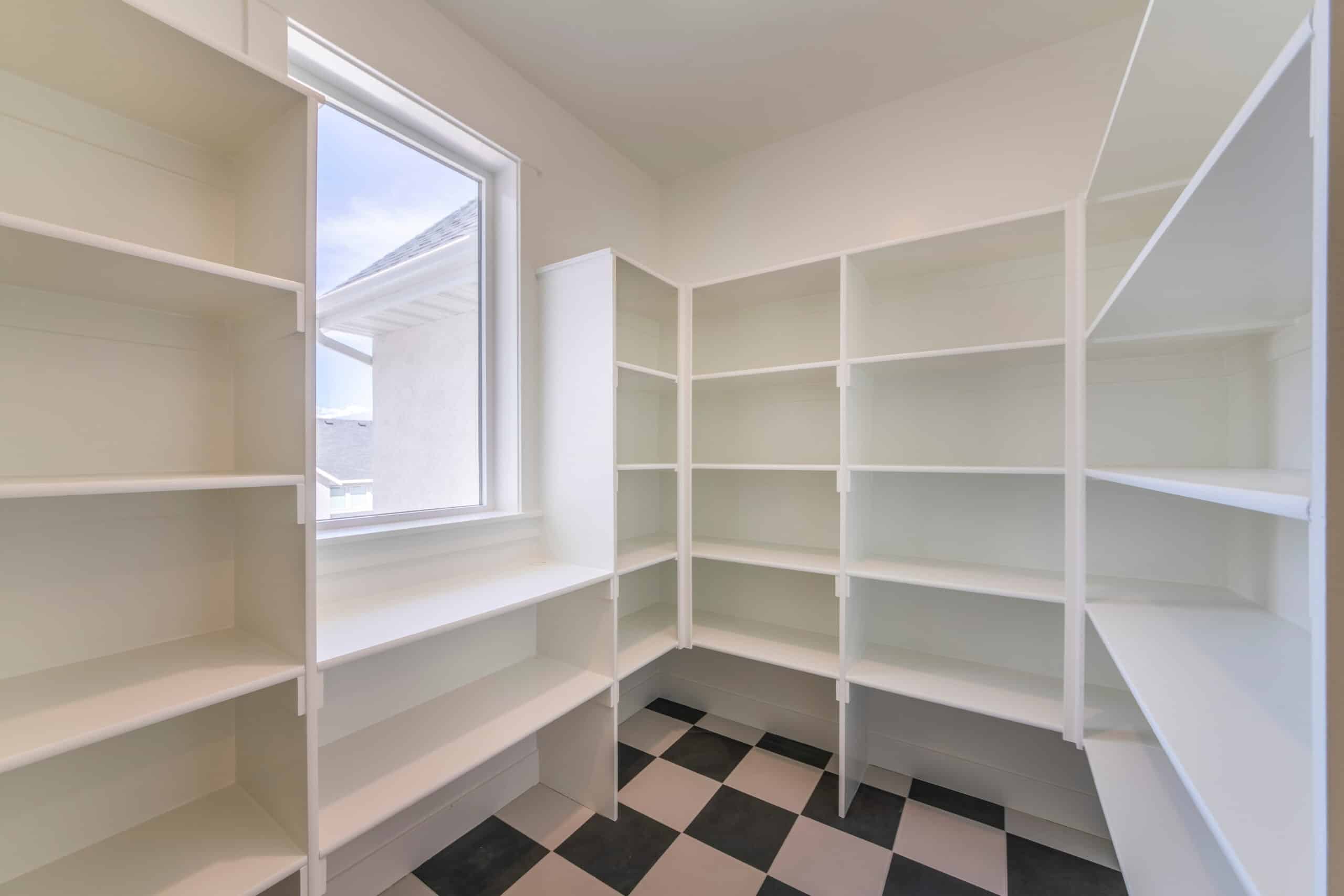 Interior of an empty kitchen pantry in a house with window